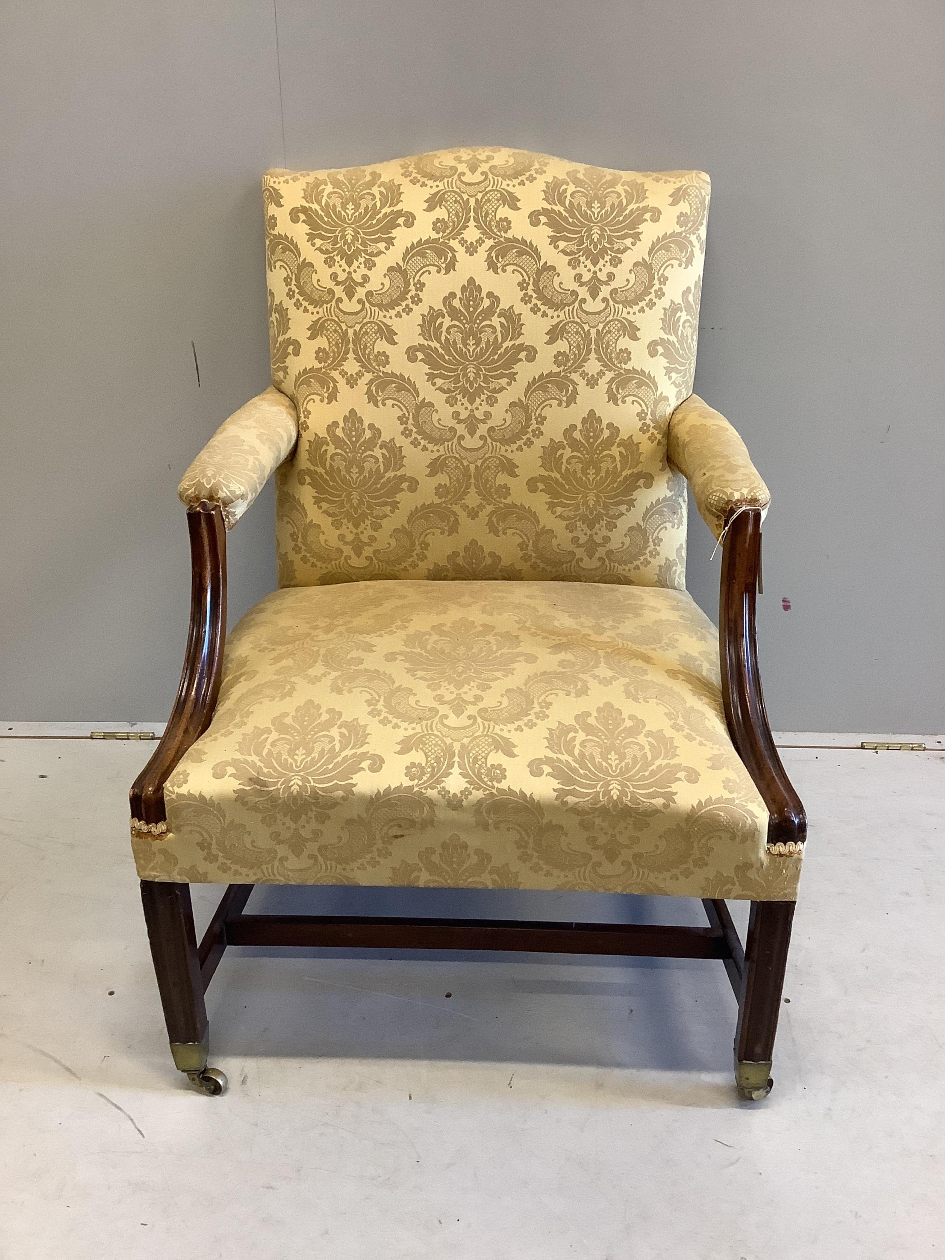 A George III mahogany Gainsborough style chair, width 72cm, depth 67cm, height 93cm. Condition - fair, old repair to both arms and front right leg, stretcher appears a later replacement.